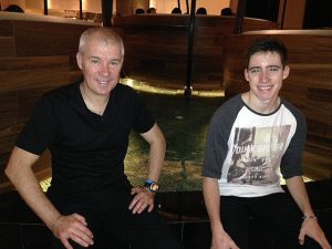 Boys sitting near hotel water feature